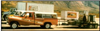 MOTHER's research team hits the highways in their fleet of alcohol-powered vehicles, with their portable still and low-cost solar systems trailer (Montana, 1982).